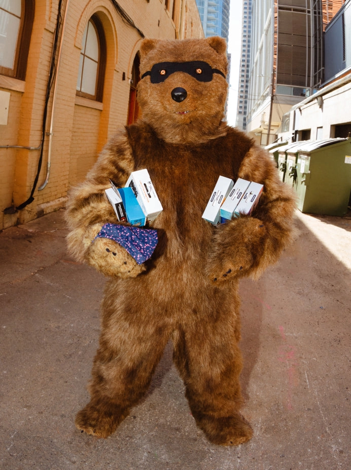 Bear mascot holding product boxes
