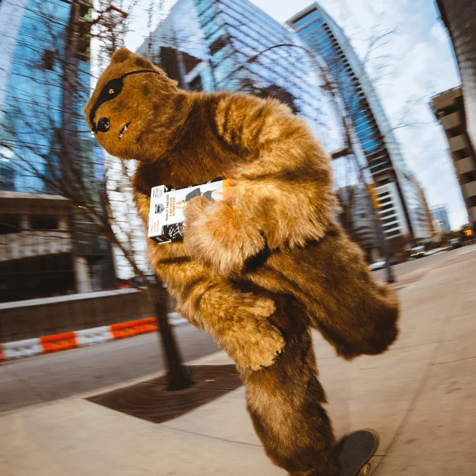 Bear mascot leaping across a city street
