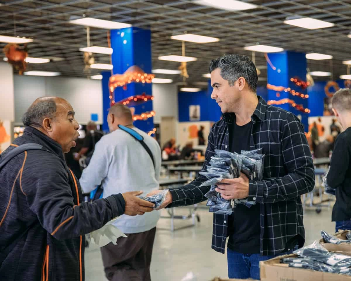 Two men exchanging Pair of Thieves packages at a busy event